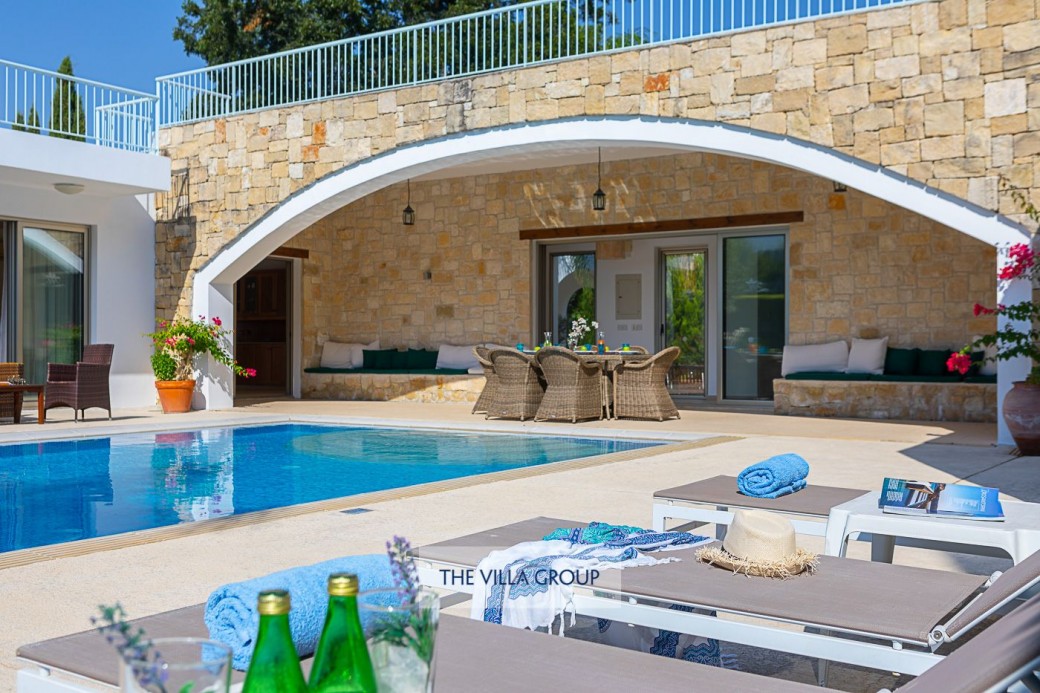 Sunbeds surround the swimming pool