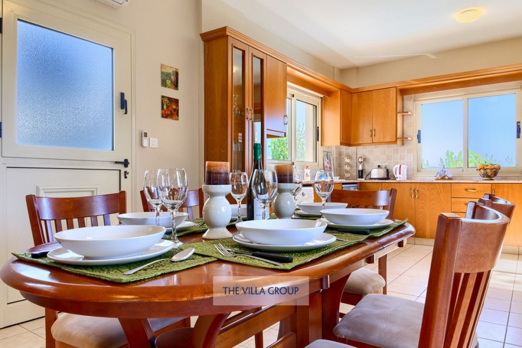 Patio doors from the dining area lead out to the swimming pool