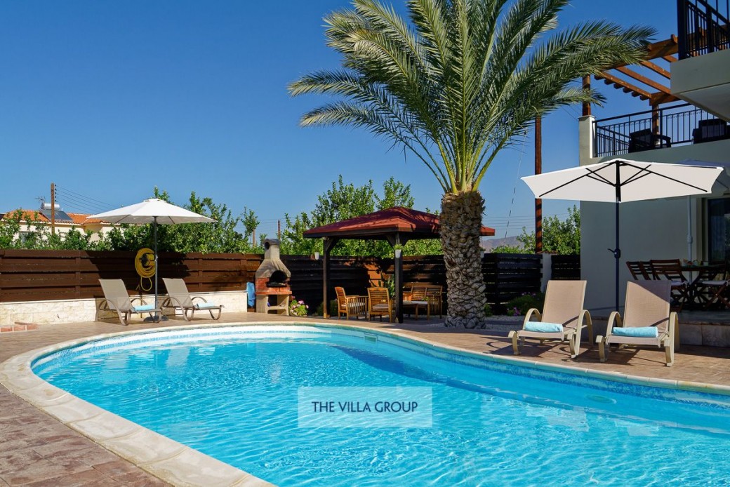 Sunbeds and umbrellas surrounding the swimming pool