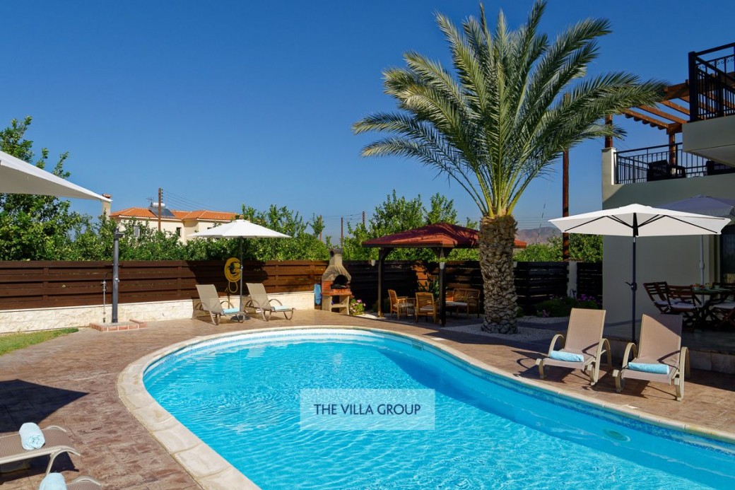 Sunbeds and umbrellas surrounding the swimming pool