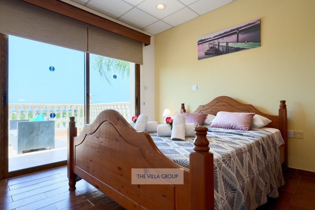 Master bedroom with access to furnished balcony