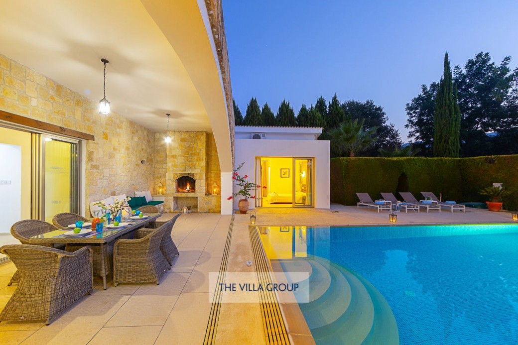 Swimming pool lit at night with walk-in steps