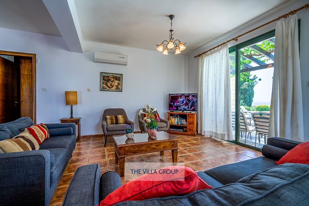 Living area with patio doors leading to the pool area