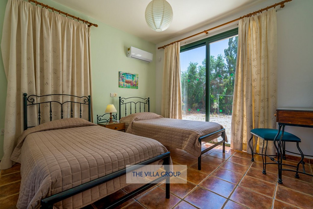 Ground floor twin bedroom with patio doors to outside