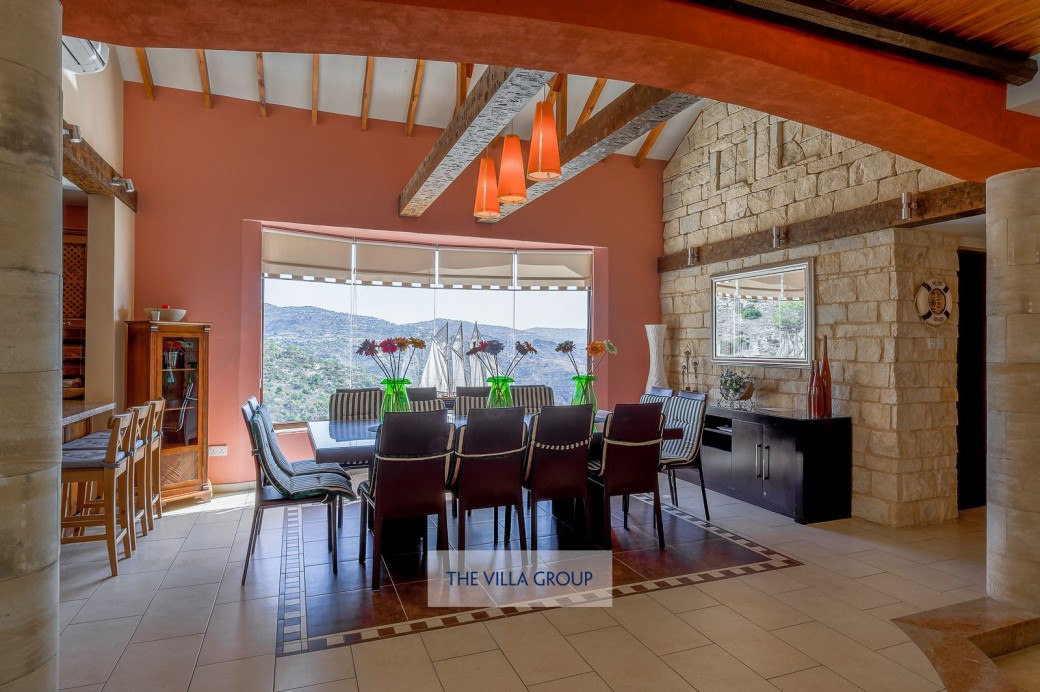 Formal dining table that can comfortably seat 12, enjoying a prime position next to the large picture window with views across the valley