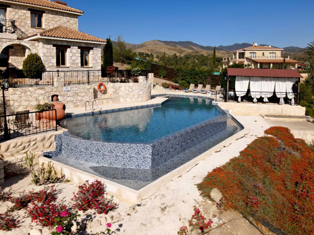 Swimming pool with an overflow feature