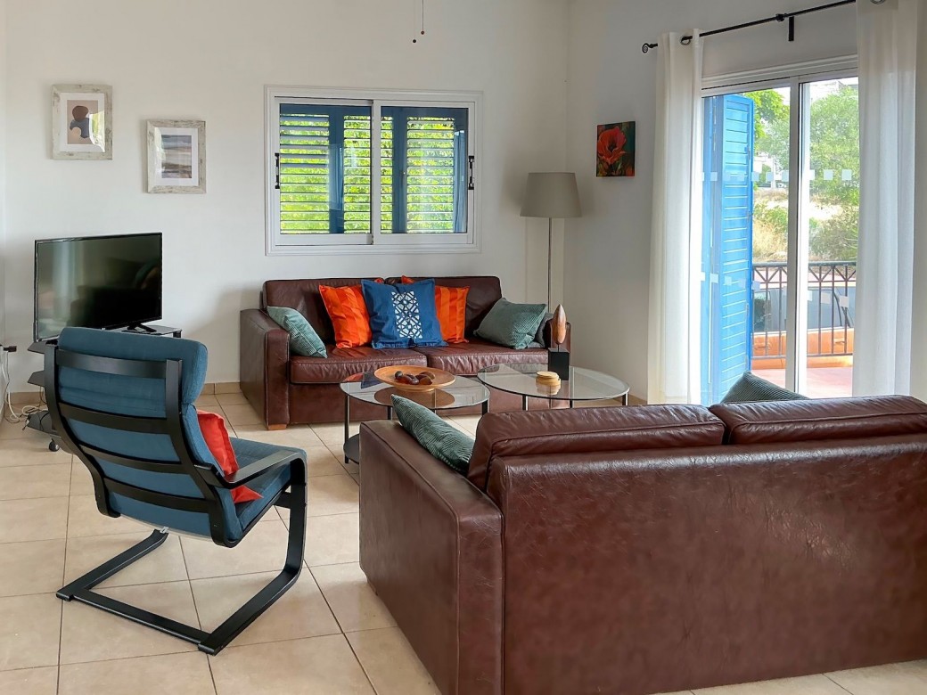 Living area with patio doors leading to furnished terrace
