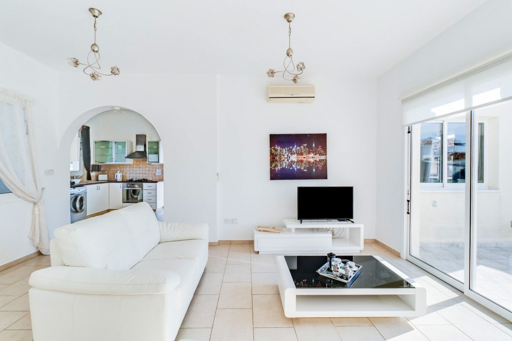 Patio doors lead from the living area to the pool terrace