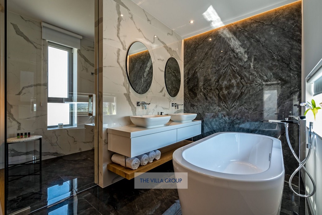 Master bedroom with tub, his n her sinks and wet room