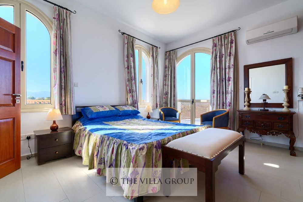 Master double bedroom with doors leading to the outside sea view terrace