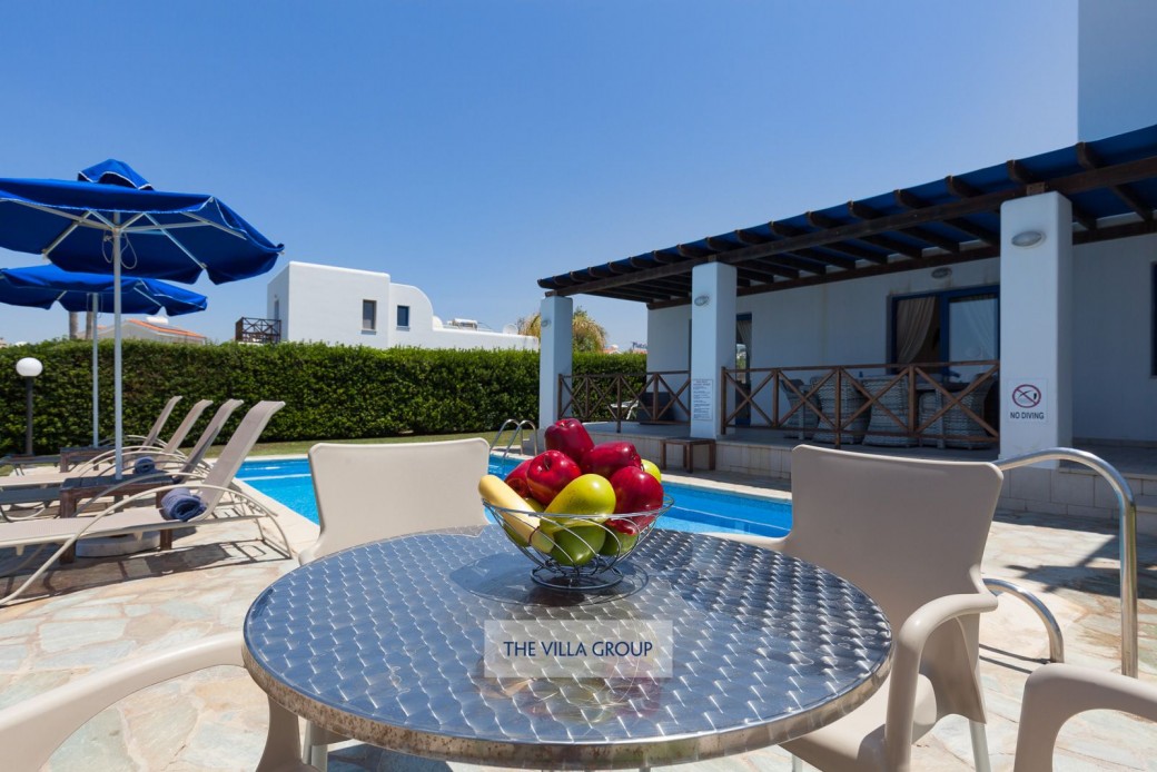 Spacious outside area with sunbeds, umbrellas and furniture