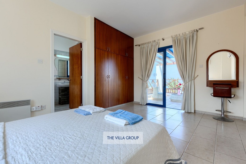 Master bedroom with private furnished balcony