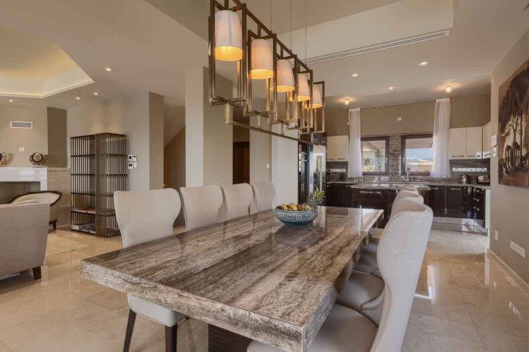 Dining area offers a gorgeous granite dining table with its signature lighting on the ceiling above it