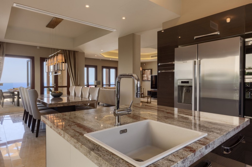 Kitchen complete with central island, granite worktops and integrated stainless-steel appliances