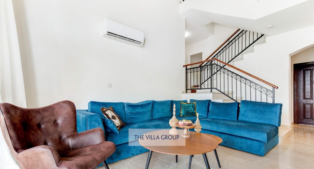 The living area has a fireplace, comfortable corner sofa and opens out to the large patio