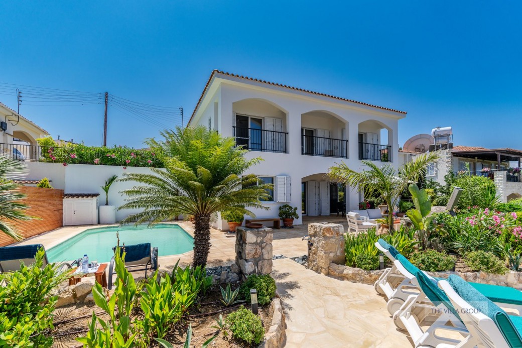 Spacious outside area with plenty of seating areas and a swimming pool