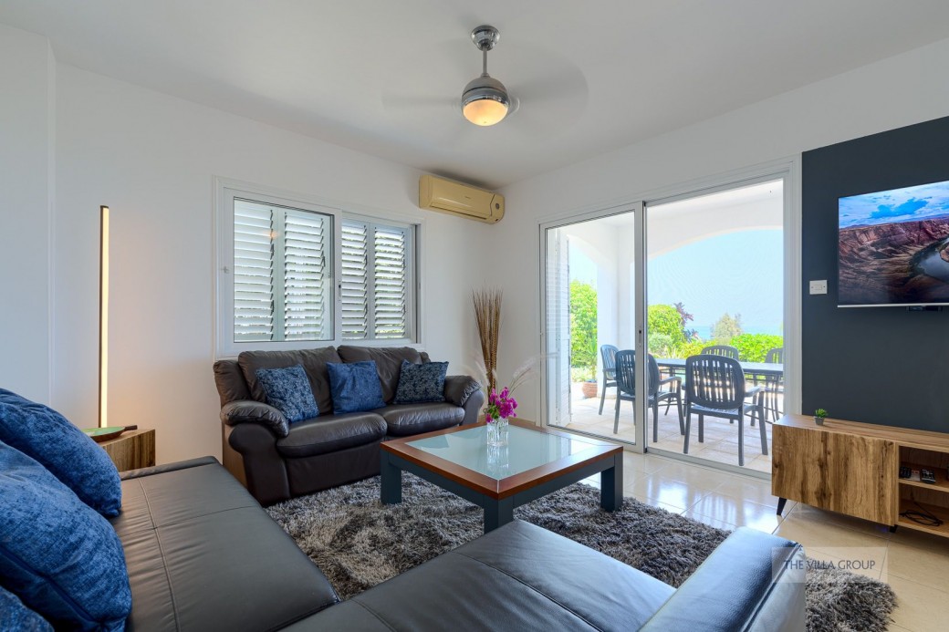 Patio doors from the living and kitchen areas leading to the outside furnished terrace