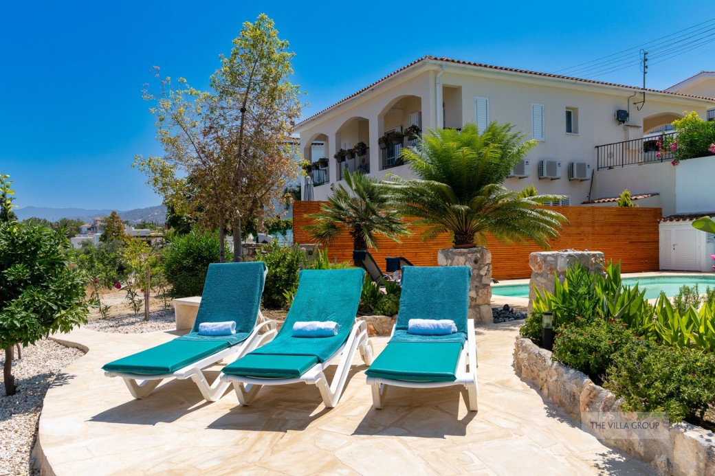 Section in the garden with sunbeds for enjoying the Cyprus sunshine