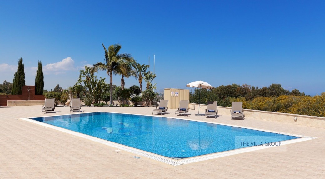 Swimming pool surrounded by sunbeds for relaxing under the Cyprus sunshine