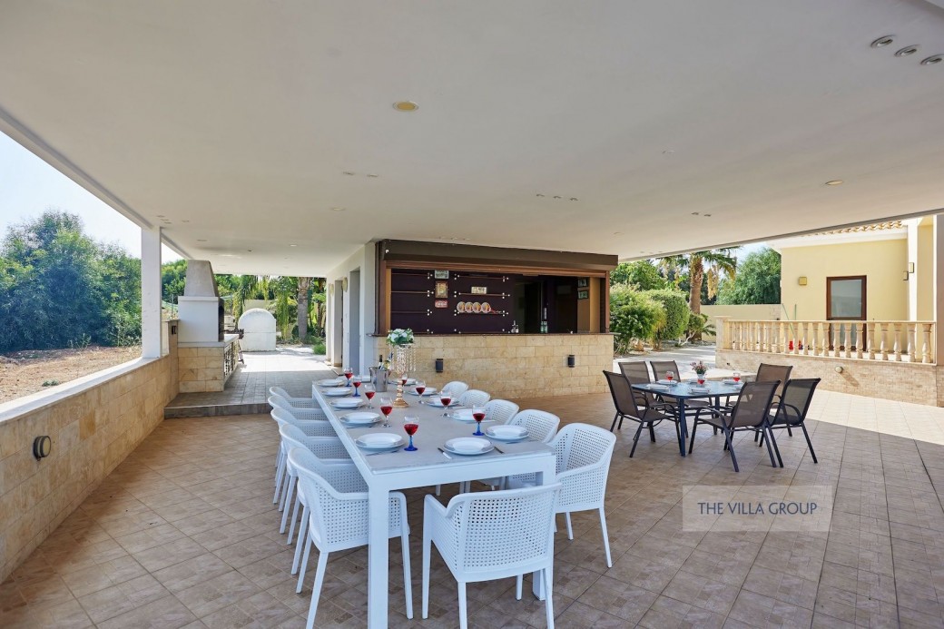 A large newly-built pergola giving plenty of covered seating area for outside dining