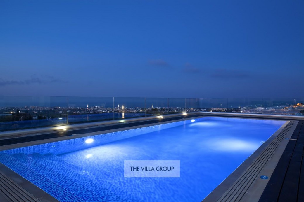 Pool lit at night with amazing views