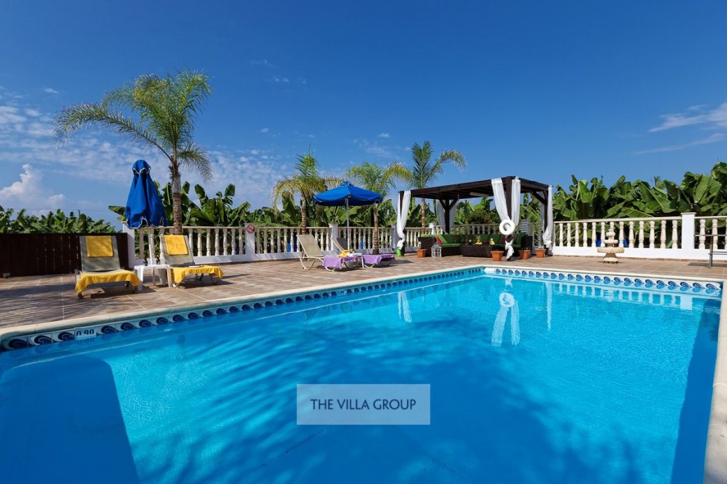 9m x 5m private swimming pool is surrounded by a paved terrace 