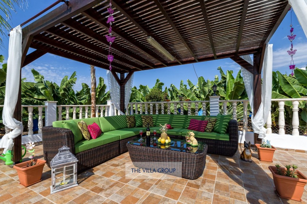 Covered seating area by pool