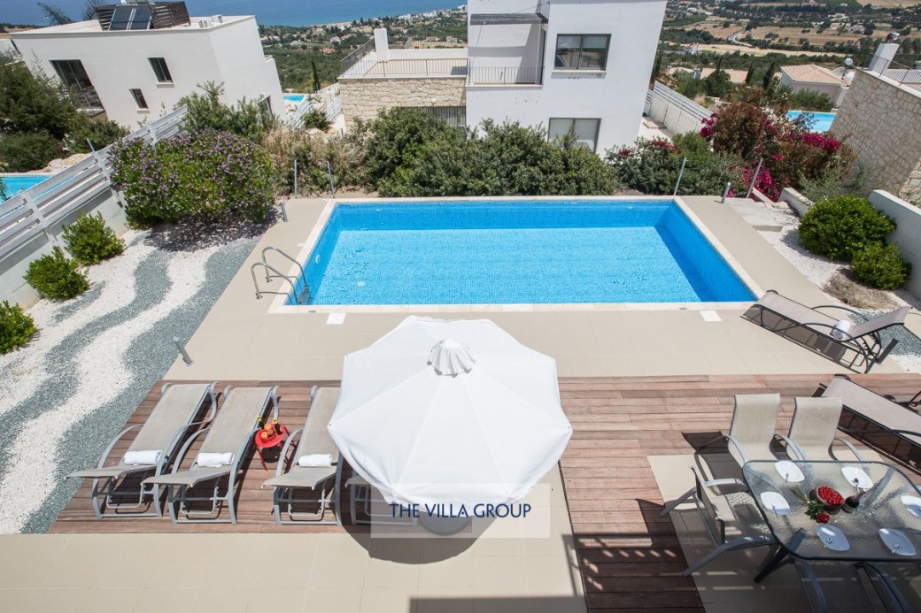 8m x 4m private swimming pool surrounded by umbrellas and sun beds