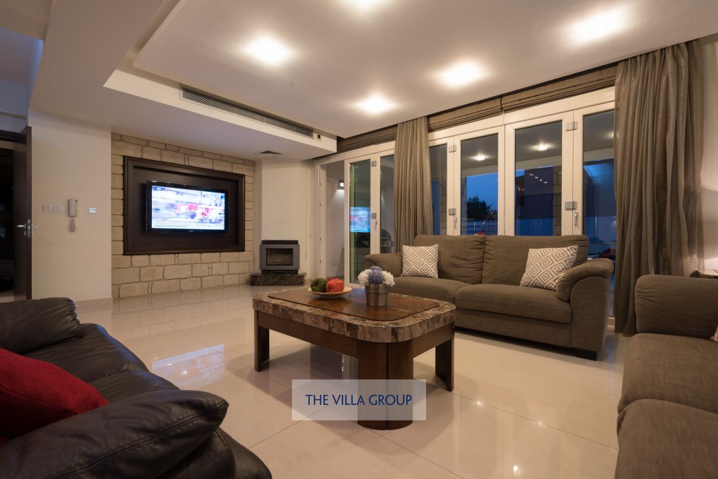 One of the two lounge areas on the ground floor with full-width folding patio doors