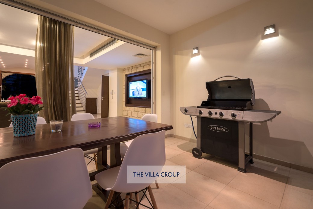 Full-width folding patio doors from the living area to the covered furnished terrace 