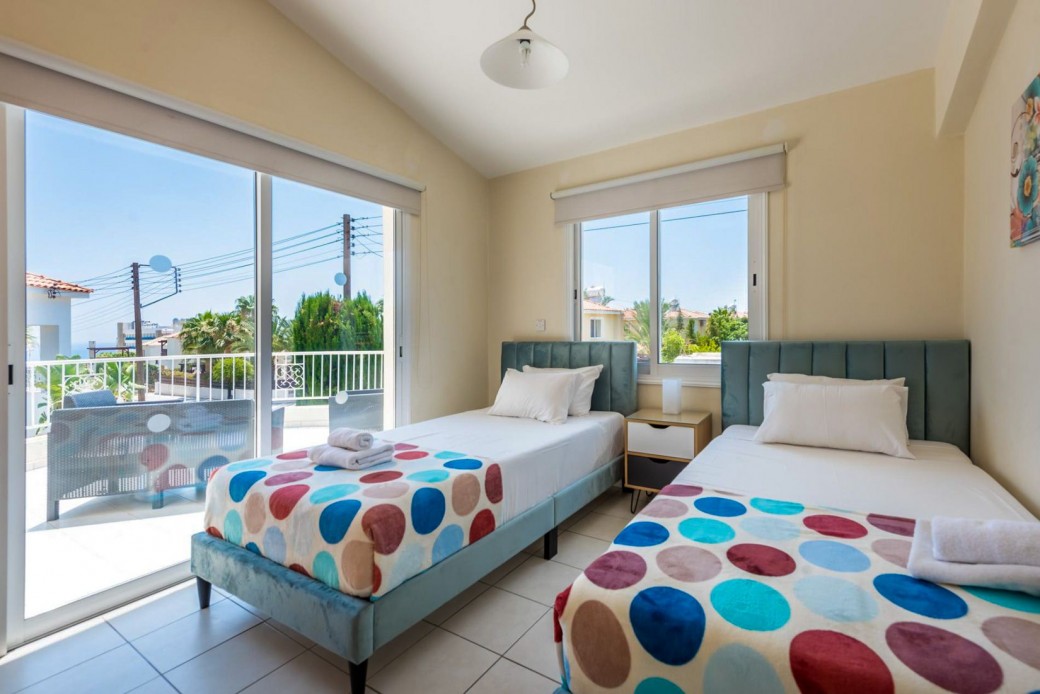 Twin bedroom with access to furnished balcony