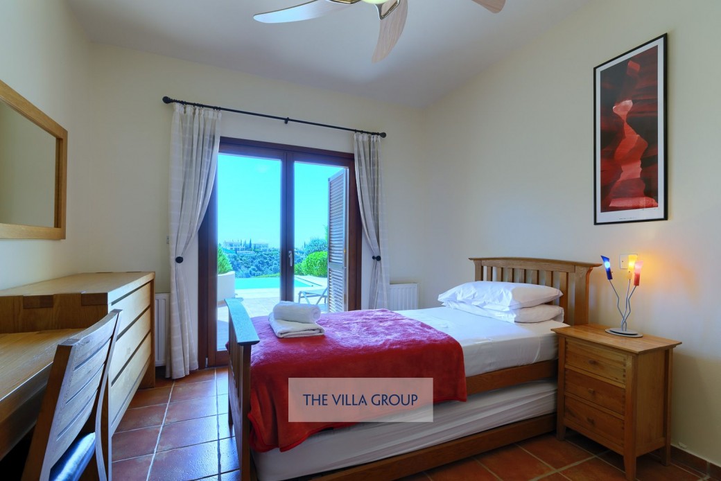 Double bedroom on ground floor with patio doors leading to pool