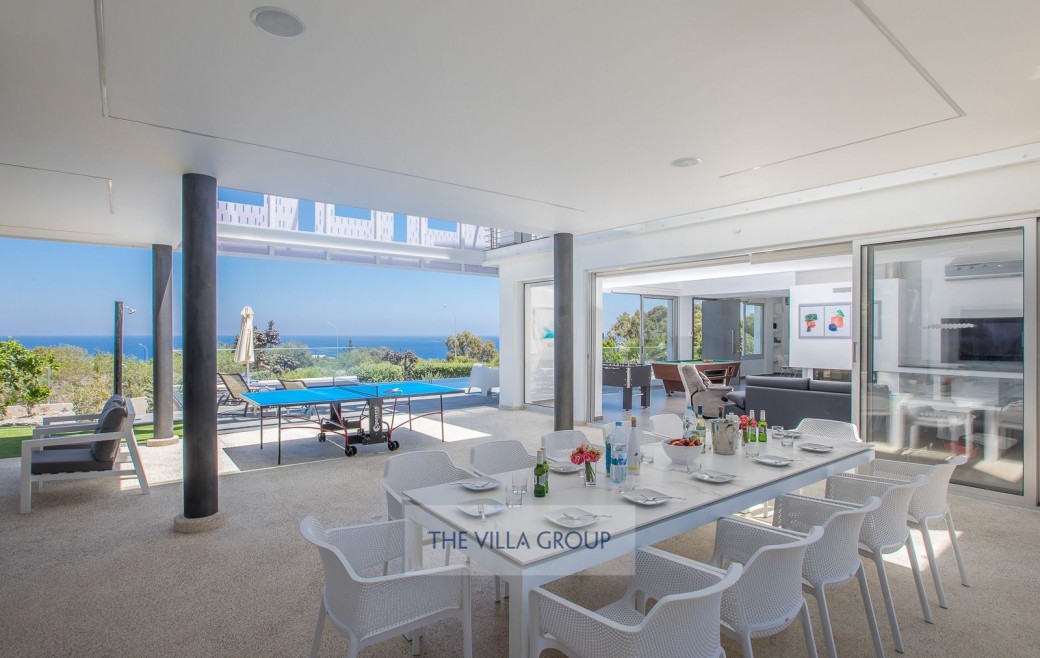 Spacious living, dining and kitchen area with patio doors that offer sea views from every angle