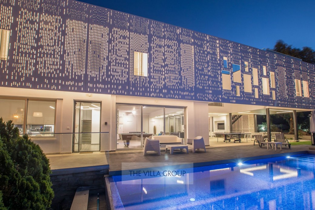 Villa and pool area at night