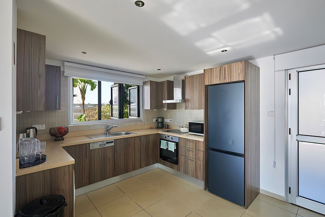 The modern kitchen is fully equipped with modern appliances