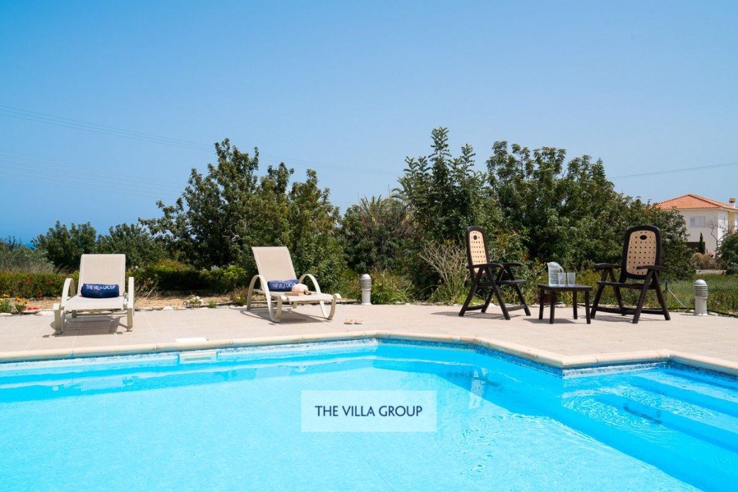 Sunbeds surrounding the swimming pool