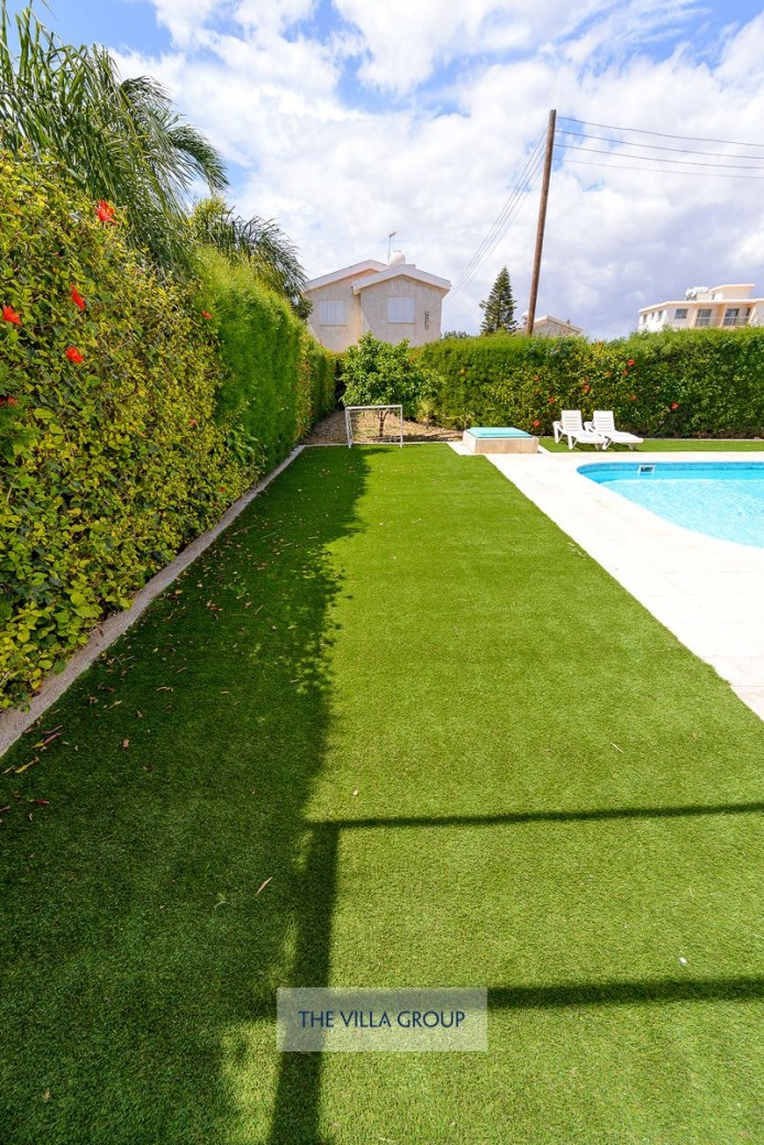 Well kept grass patch around swimming pool