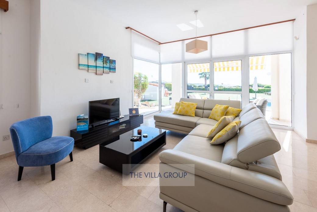 Living area with patio doors leading out onto the furnished veranda