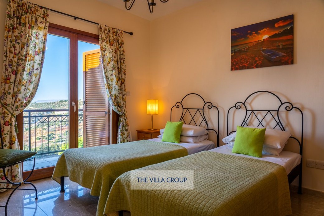 Twin bedroom with patio doors leading to balcony