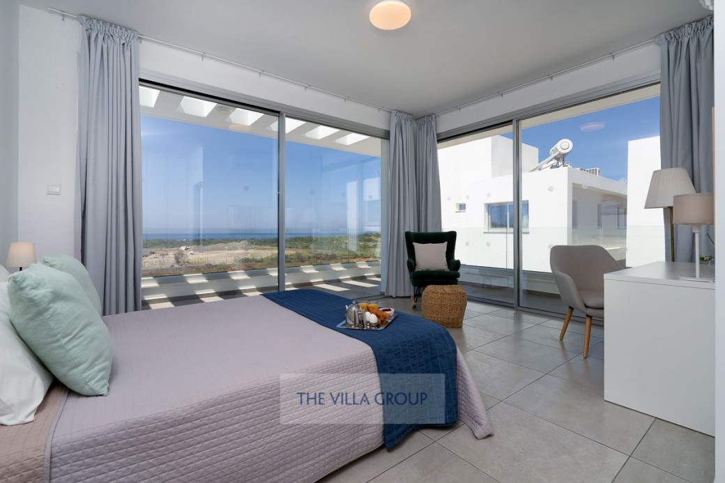 Spacious bedroom with patio doors leading to the balcony