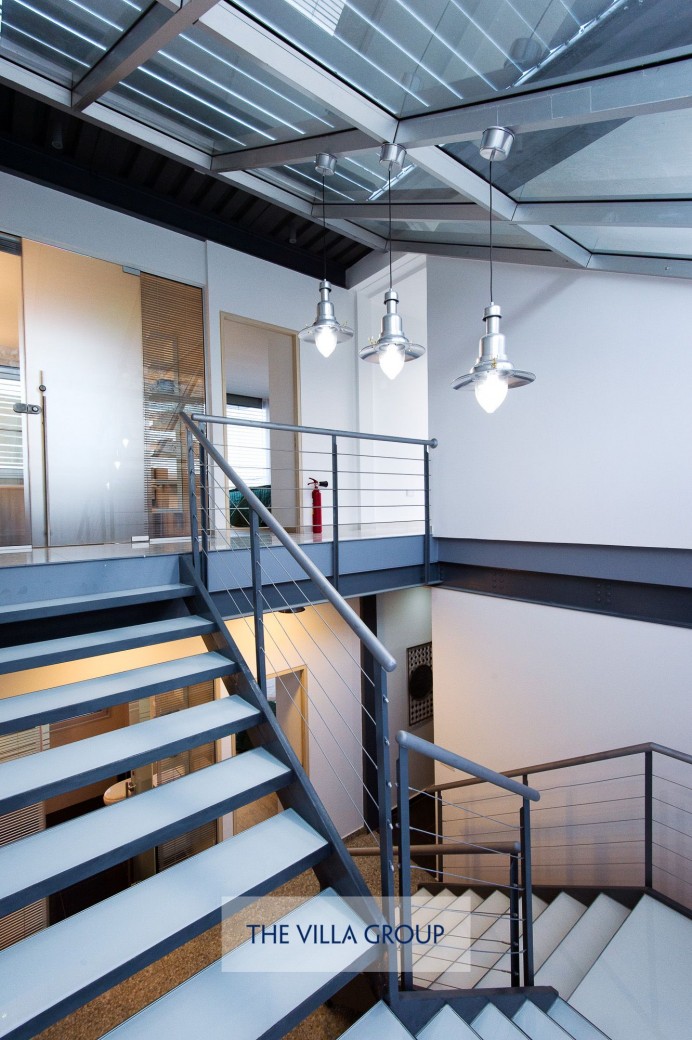 Elegant staircase covered with glazed atrium