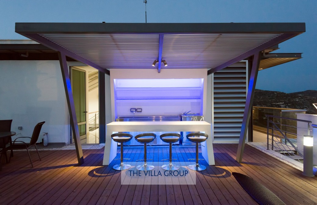 Bar area on roof terrace lit at night