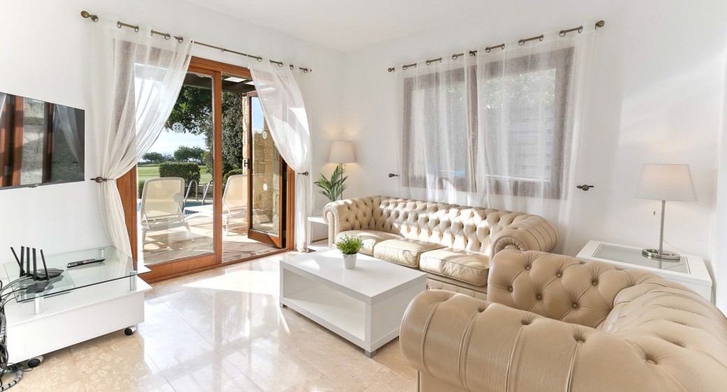 Large open plan living and dining area with double patio doors leading to the terrace