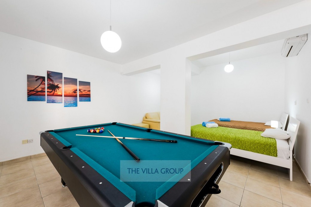 Lower ground floor has twin bedroom and area with pool table
