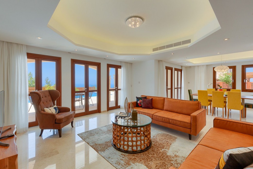 The beautifully furnished living area boasts rustic coloured sofas