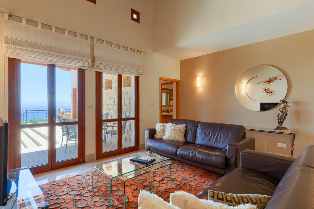 Large windows opening out to the pool and patio area