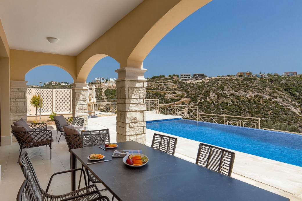 Shady spot featuring dining table and comfortable cushioned chairs for al-fresco dining and relaxing