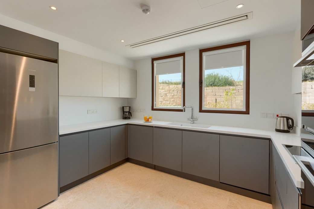 The kitchen is fitted with stylish high-gloss units and well stocked with all necessary utensils and top quality equipment