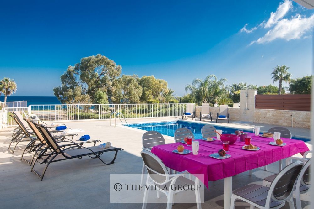 Al fresco dining area adjacent to the swimming pool