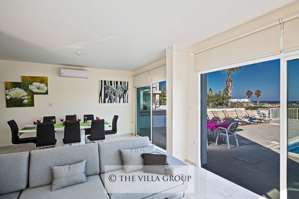 Large patio doors leading out onto the swimming pool terrace
